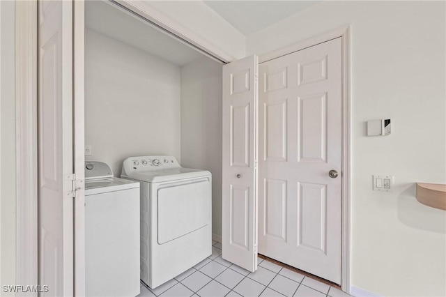 laundry area featuring independent washer and dryer and light tile patterned floors