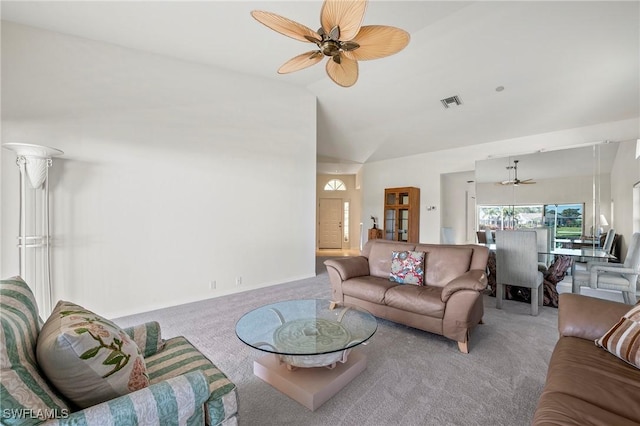 living room featuring ceiling fan, vaulted ceiling, and carpet