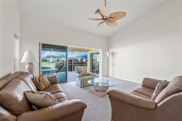 carpeted living room with high vaulted ceiling and ceiling fan