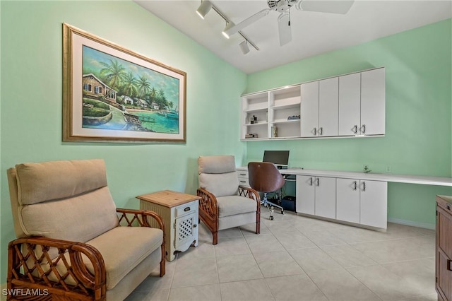 tiled office featuring built in desk, ceiling fan, and track lighting