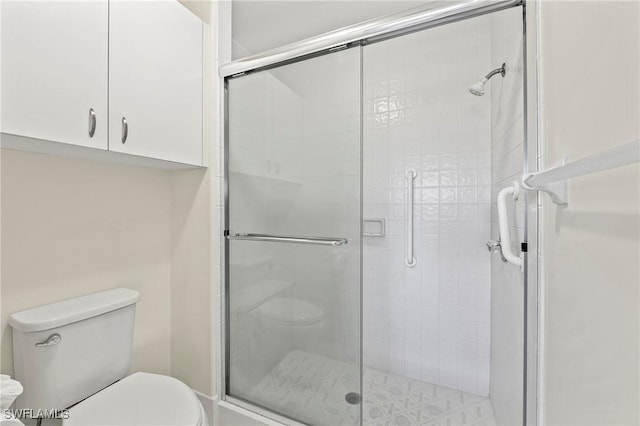 bathroom featuring toilet and walk in shower