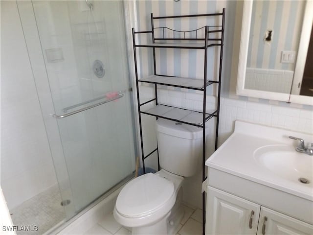 14 Richmond Ave N, Lehigh Acres, FL 33936 - bathroom featuring vanity, toilet, a shower with shower door, and tile walls