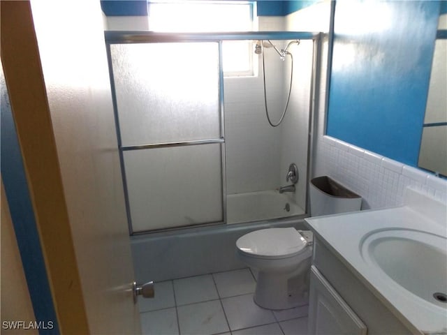 14 Richmond Ave N, Lehigh Acres, FL 33936 - full bathroom with enclosed tub / shower combo, tile patterned flooring, tile walls, vanity, and toilet