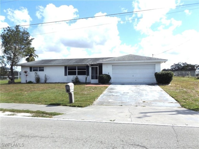 single story home featuring a garage and a front lawn