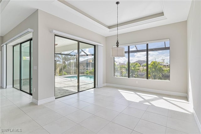 unfurnished dining area featuring light tile patterned floors and a raised ceiling