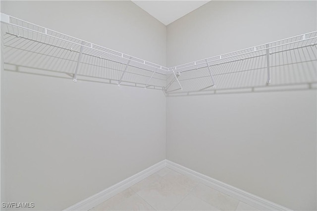 walk in closet featuring tile patterned flooring