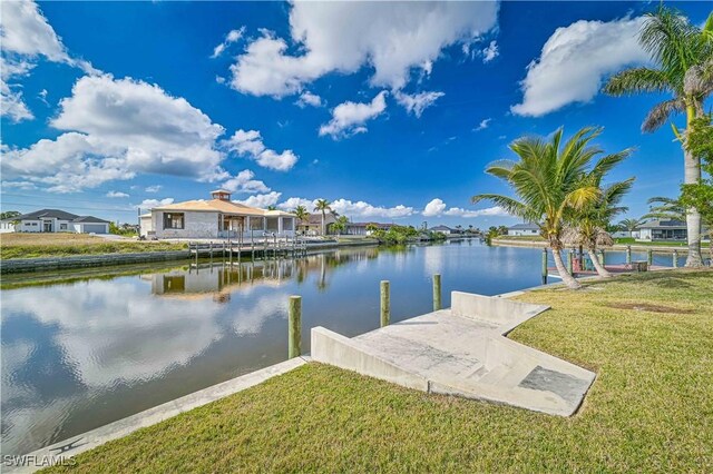 dock area featuring a lawn and a water view