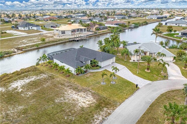 birds eye view of property with a residential view and a water view