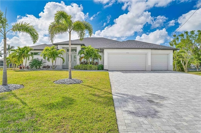 view of front facade featuring an attached garage, stucco siding, decorative driveway, and a front yard