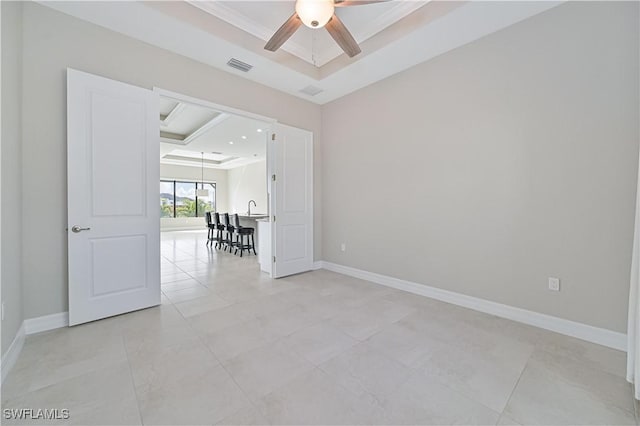 unfurnished room featuring crown molding, a raised ceiling, and ceiling fan