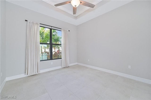 unfurnished room featuring ceiling fan and a tray ceiling