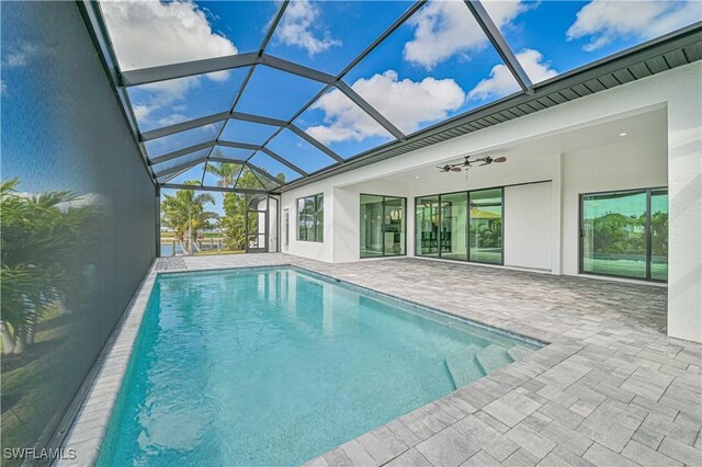 view of pool featuring ceiling fan, a lanai, and a patio area