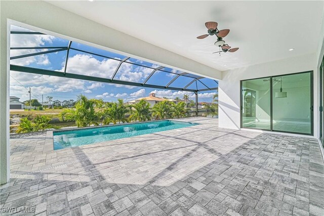 view of swimming pool with a lanai, a patio, and ceiling fan