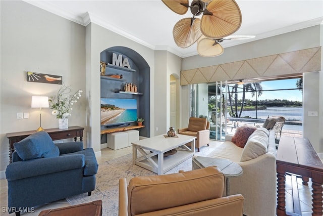 living room featuring crown molding, ceiling fan, and built in features