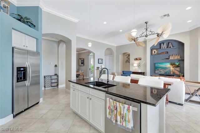 kitchen featuring light tile patterned flooring, sink, an island with sink, stainless steel appliances, and white cabinets