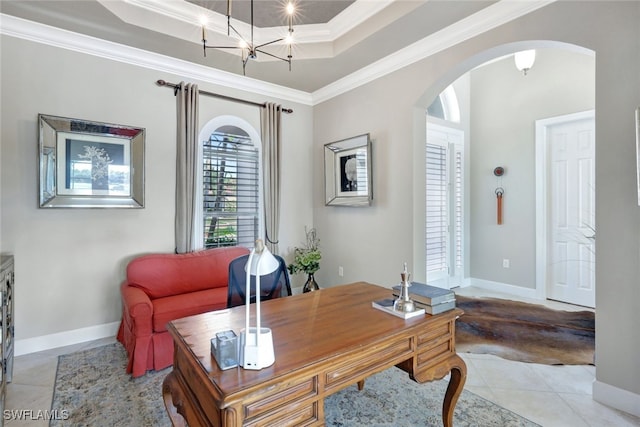 tiled office space featuring crown molding and a tray ceiling