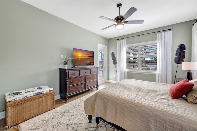 bedroom with ceiling fan, access to exterior, and light hardwood / wood-style flooring