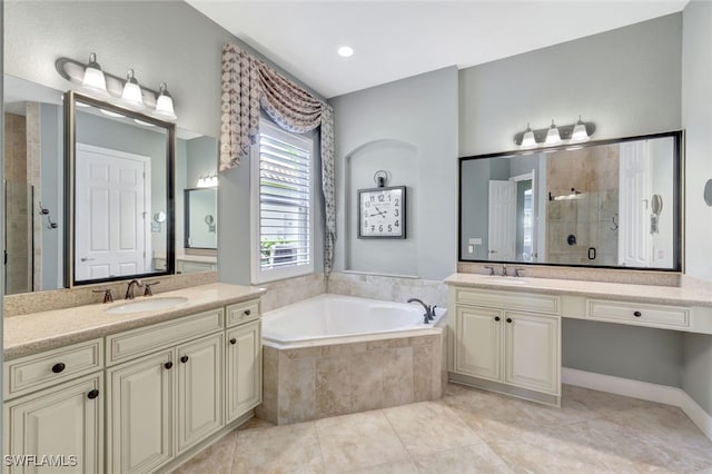 bathroom with tile patterned floors, vanity, and shower with separate bathtub