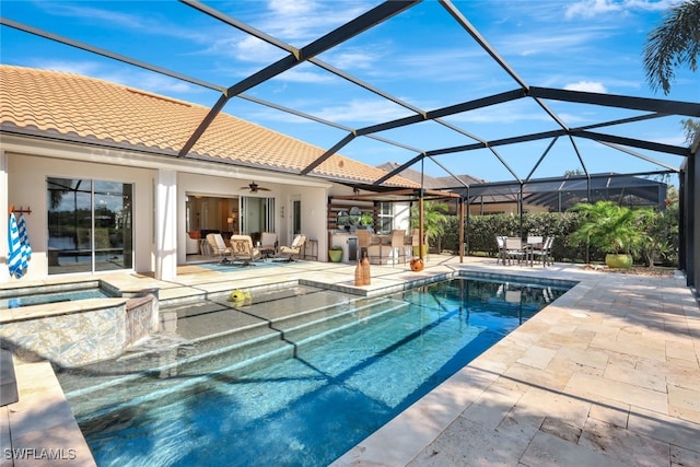 view of swimming pool with a patio, outdoor lounge area, an in ground hot tub, ceiling fan, and glass enclosure