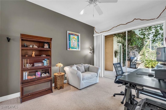 carpeted office space with vaulted ceiling and ceiling fan