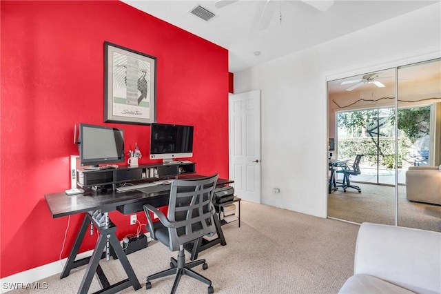 carpeted office featuring ceiling fan