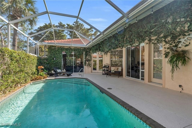 view of pool with a lanai and a patio