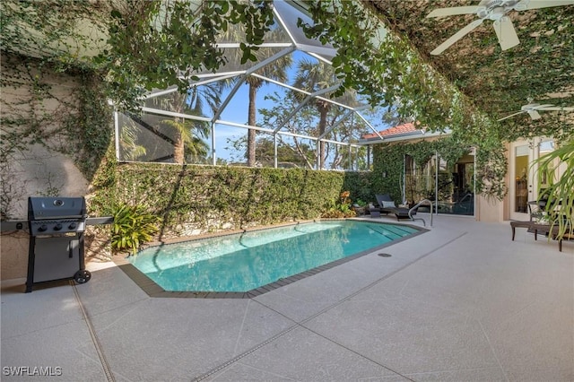 view of swimming pool with grilling area, glass enclosure, and a patio