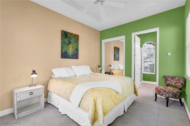 carpeted bedroom featuring ceiling fan and a closet