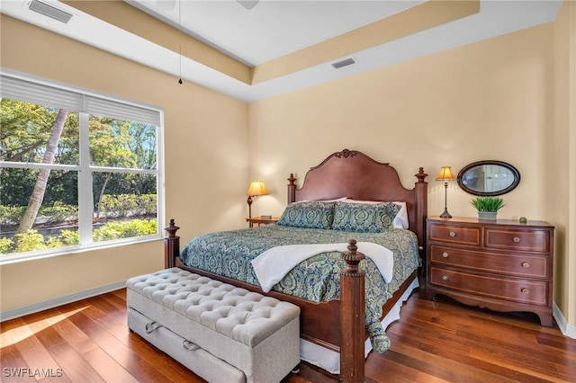 bedroom with dark hardwood / wood-style flooring