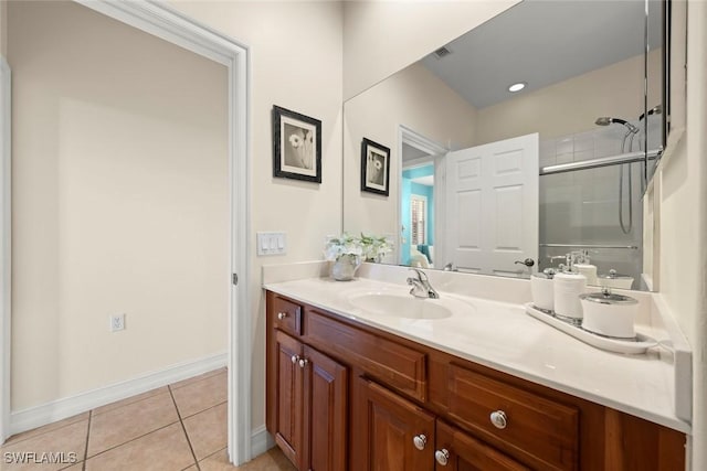 bathroom featuring vanity, an enclosed shower, and tile patterned flooring