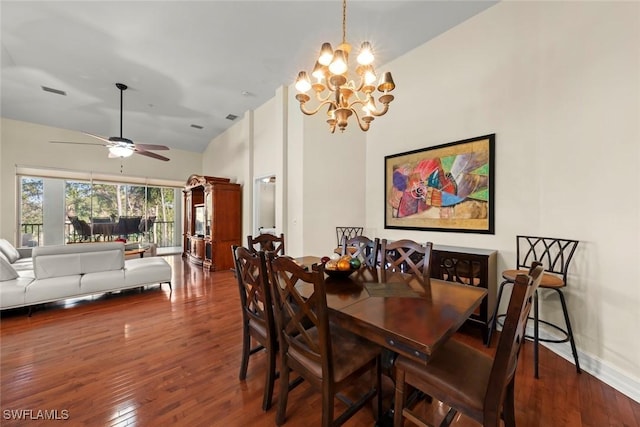 dining area featuring ceiling fan with notable chandelier, dark hardwood / wood-style floors, and high vaulted ceiling