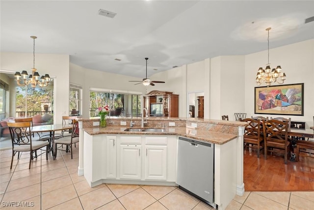 kitchen with dishwasher, sink, pendant lighting, and white cabinets