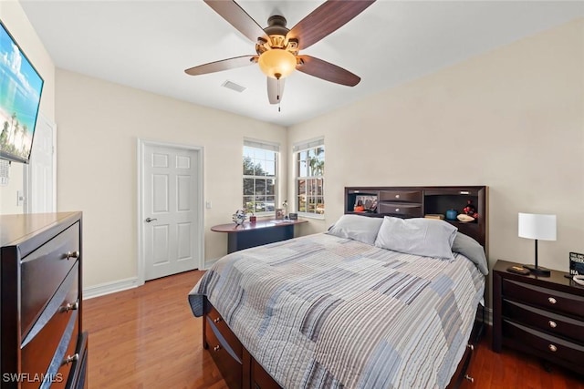 bedroom with dark wood-type flooring and ceiling fan