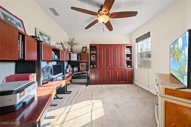 carpeted home office with ceiling fan