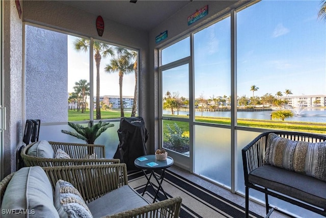 sunroom with a water view and plenty of natural light