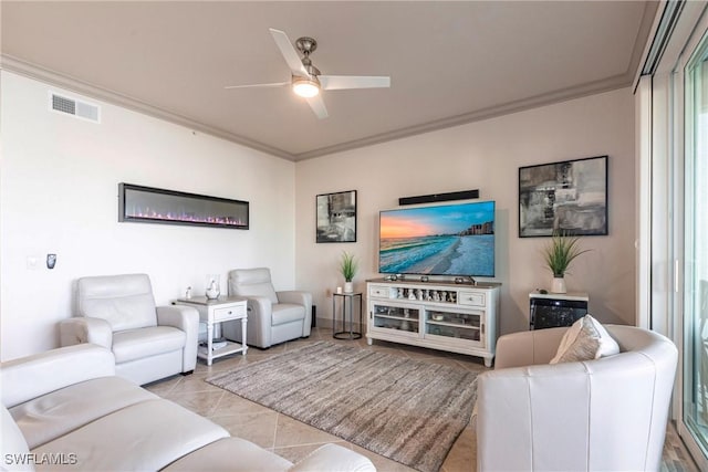 living room with ornamental molding, light tile patterned floors, and ceiling fan