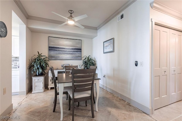 dining area with crown molding and ceiling fan