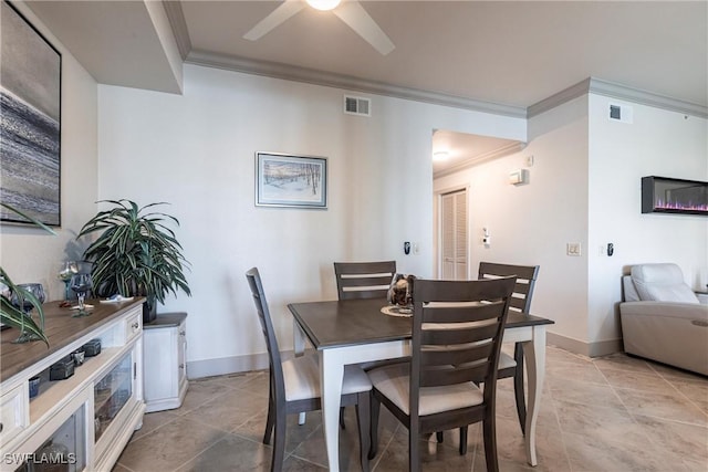 dining space featuring ornamental molding and ceiling fan