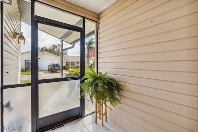 entryway with light tile patterned floors