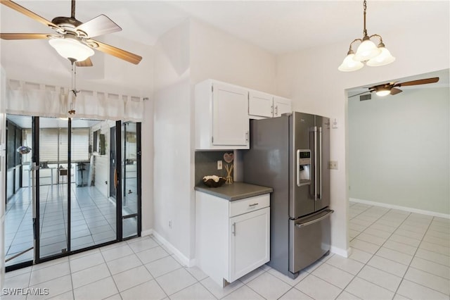 kitchen with light tile patterned flooring, high end fridge, white cabinetry, decorative light fixtures, and ceiling fan