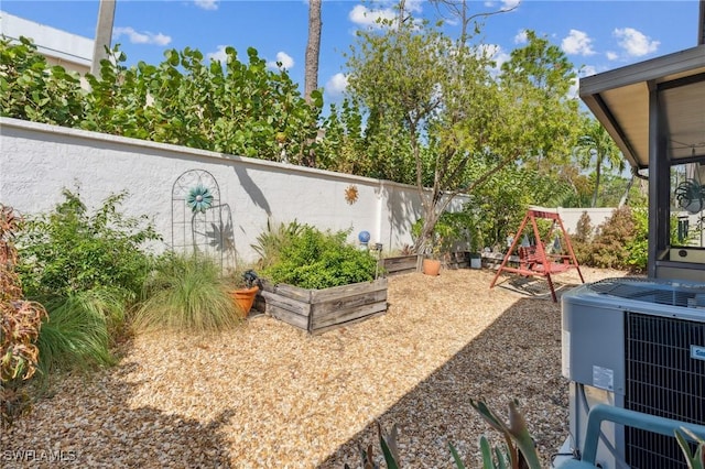 view of yard with a playground and central air condition unit