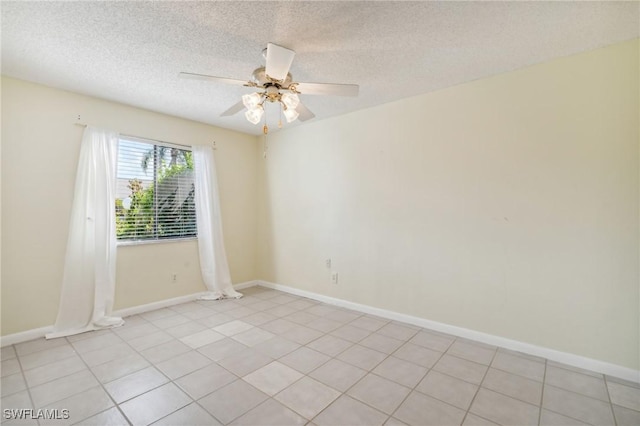 tiled spare room featuring a textured ceiling and ceiling fan