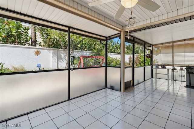 unfurnished sunroom with ceiling fan