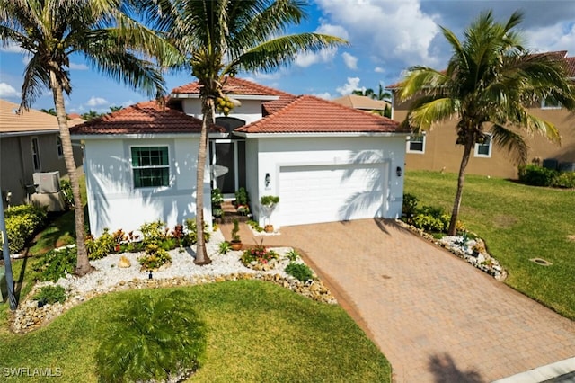 mediterranean / spanish-style house featuring a garage and a front yard