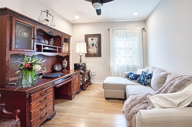 office space featuring a ceiling fan, recessed lighting, baseboards, and light wood finished floors