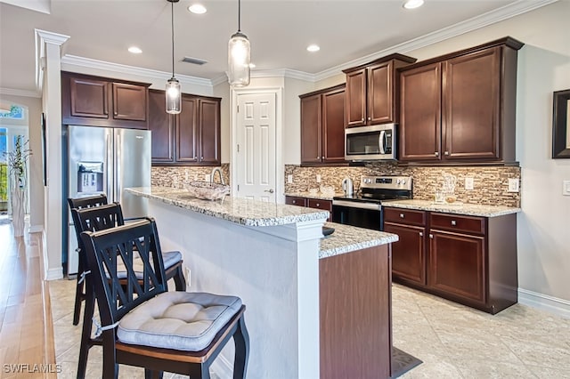 kitchen featuring ornamental molding, stainless steel appliances, dark brown cabinets, and pendant lighting