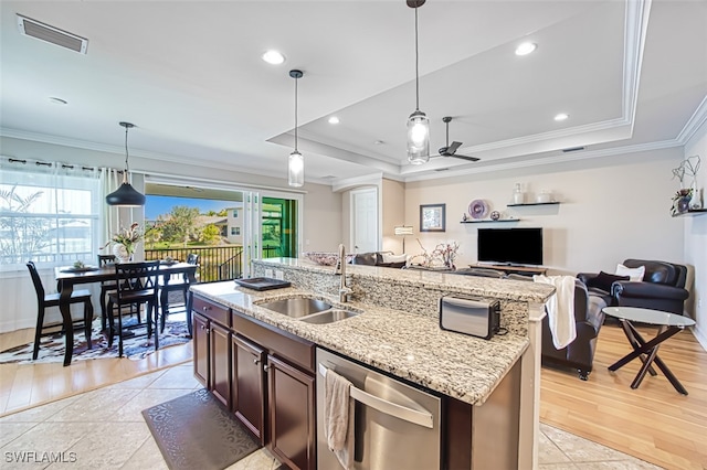 kitchen with a raised ceiling, visible vents, a sink, and dishwasher