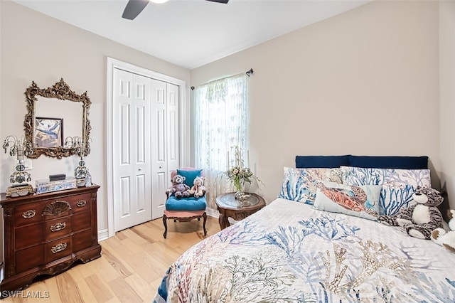 bedroom featuring ceiling fan, a closet, and wood finished floors