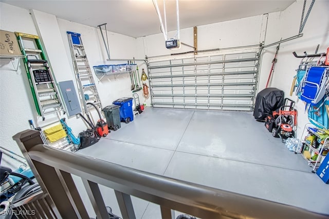 garage featuring electric panel and a garage door opener