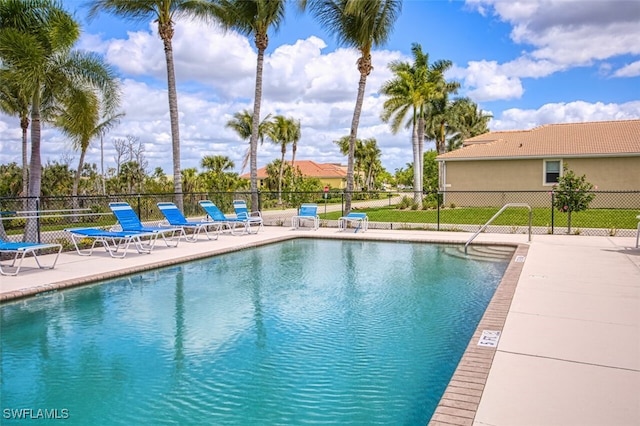 community pool featuring a patio area and fence